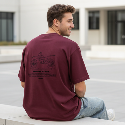 Male model back pose - sitting ledge urban plaza - Yamaha YZ250 maroon tee